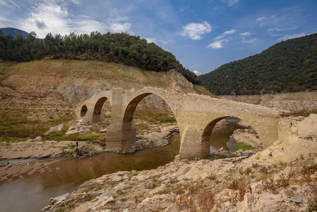 Querós Bridge, an old medieval bridge submerged under the water of the Susqueda reservoir and refloated during the 2022-23 drought (La Selva, Spain)