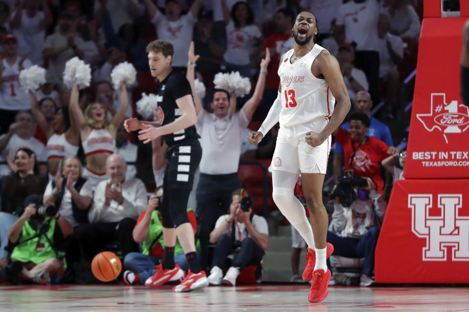 Houston forward J'Wan Roberts (13) reacts after dunking against Cincinnati during the first half of an NCAA college basketball game Tuesday, Feb. 27, 2024, in Houston. (AP Photo/Michael Wyke)