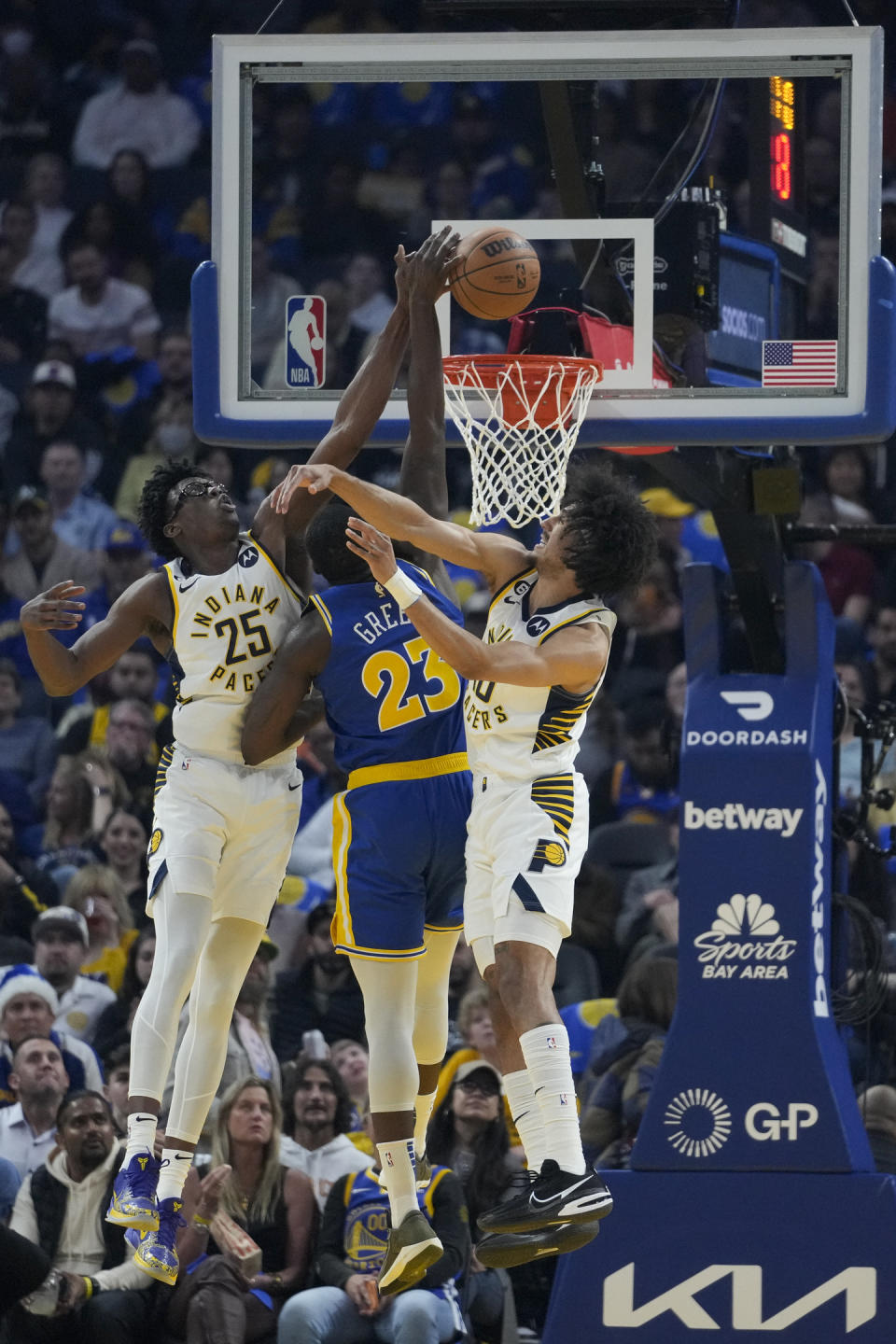 Indiana Pacers forward Jalen Smith (25) blocks a shot by Golden State Warriors forward Draymond Green (23) during the first half of an NBA basketball game in San Francisco, Monday, Dec. 5, 2022. (AP Photo/Godofredo A. Vásquez)
