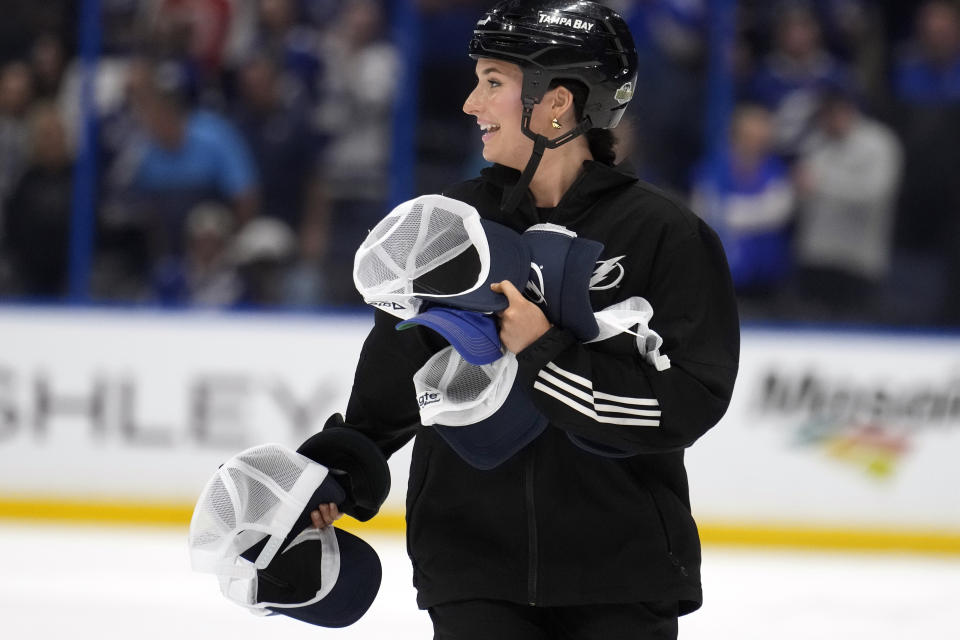 A member of the Tampa Bay Lightning ice crew pick up hats after Lightning center Steven Stamkos scored his third goal of the game against the Columbus Blue Jackets during the third period of an NHL hockey game Tuesday, April 9, 2024, in Tampa, Fla. (AP Photo/Chris O'Meara)