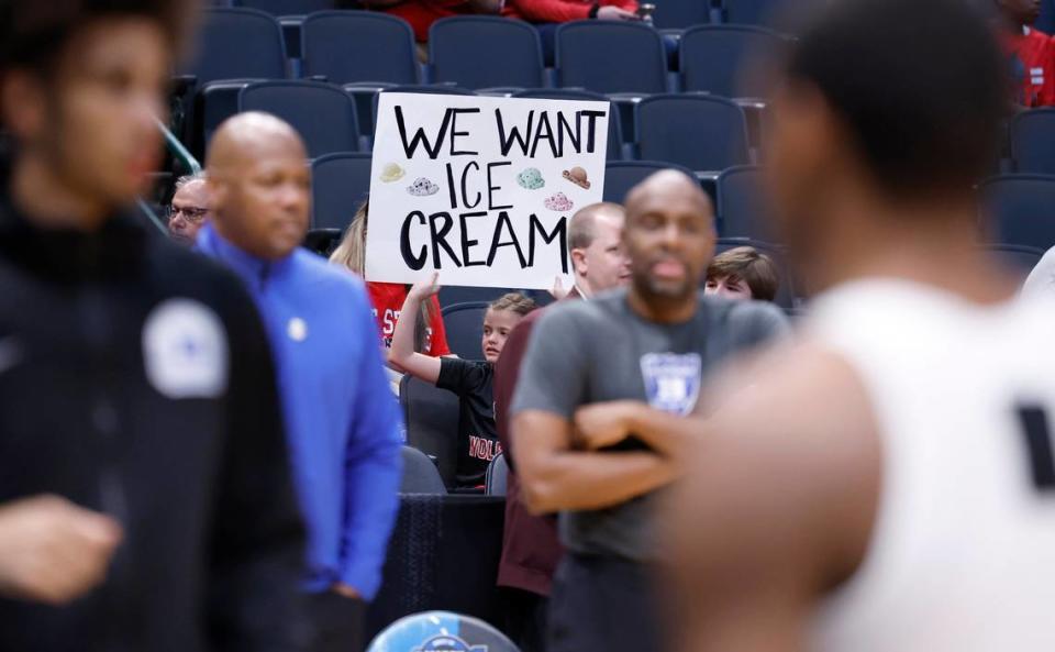 A Wolfpack fan holds up a sign as Duke warms up before N.C. State’s game against Duke in their NCAA Tournament Elite Eight matchup at the American Airlines Center in Dallas, Texas, Sunday, March 31, 2024.