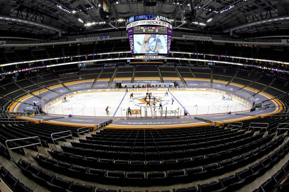 The Pittsburgh Penguins face off in the first period of an NHL hockey game against the Washington Capitals with no fans in attendance at PPG Paints Arena in Pittsburgh, Sunday, Jan. 17, 2021. It is the season home opener for the Penguins. (AP Photo/Gene J. Puskar)