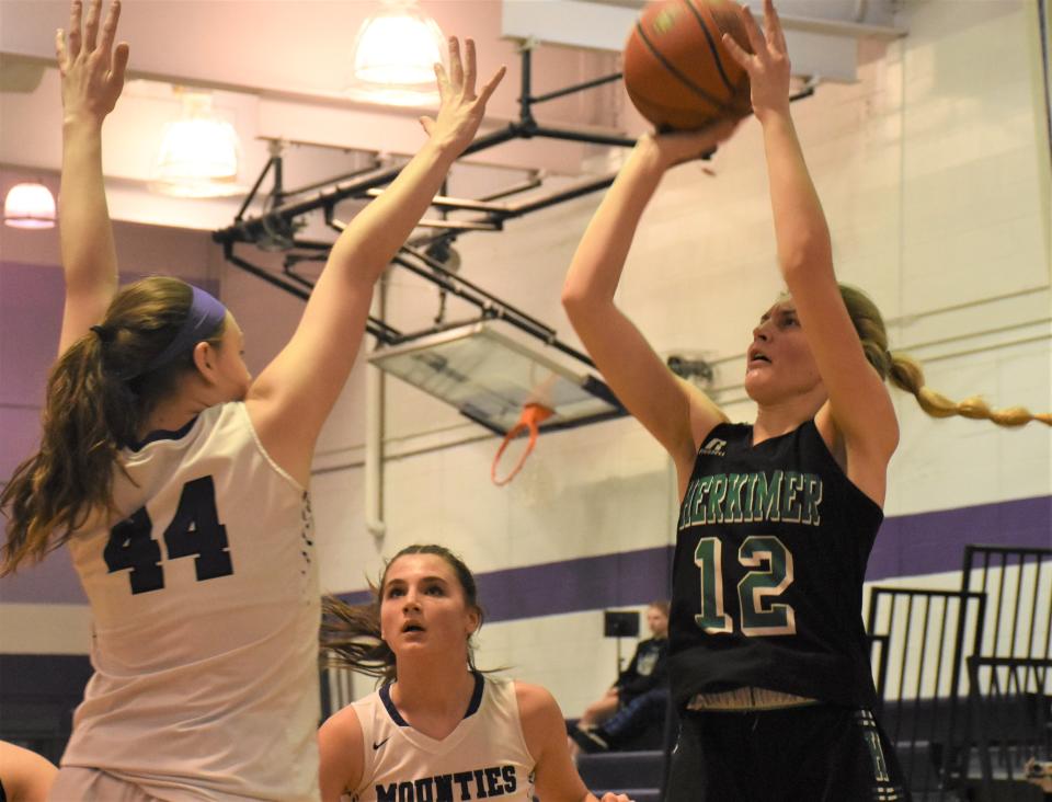 Herkimer Magician Madison Marusic (12) puts up a shot contested by Little Falls Mountie Molly Podlas during a Jan. 31 game in Little Falls. The teams meet for the third time this season Saturday on a third different court.