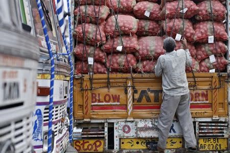 A labourer prepares to unload sacks of potatoes from a truck at a wholesale vegetable and fruit market in New Delhi July 2, 2014. REUTERS/Anindito Mukherjee/Files