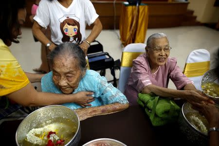 Somjit Phuthasiri (R), 90, attends Songkran festival at Wellness Nursing Home Center in Ayutthaya, Thailand, April 9, 2016. REUTERS/Athit Perawongmetha