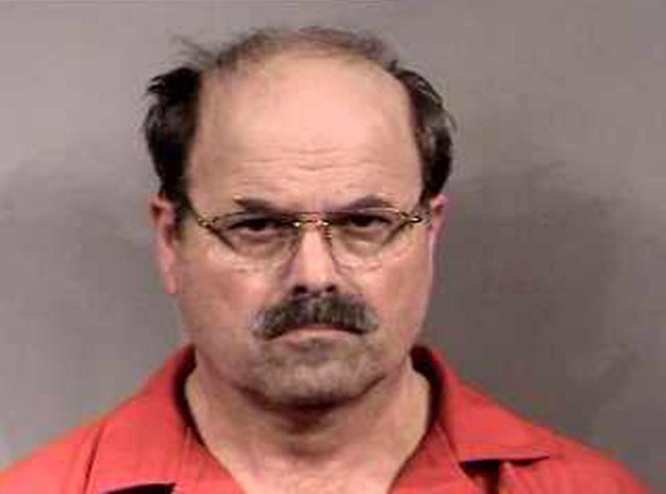 Headshot of balding, older man with glasses