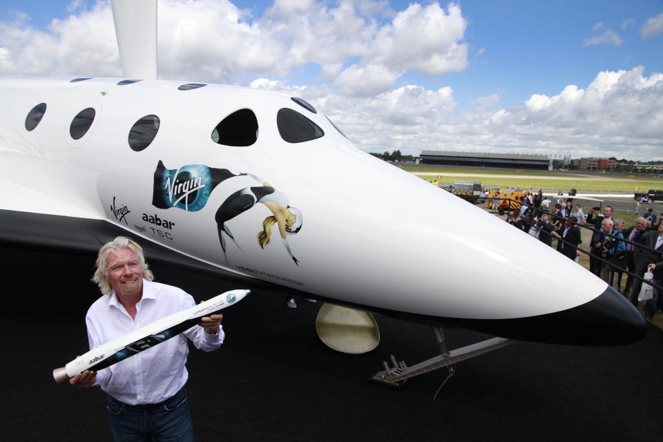 British billionaire Richard Branson poses for the photographers beside a replica of the Virgin Galactic, which according to the company will be the world’s first commercial spaceline, at the Farnborough International Airshow in Farnborough, England, Wednesday, July 11, 2012.Virgin Galactic announced “LauncherOne,” a new air-launched rocket specifically designed to deliver small satellites into orbit. Commercial flights of the new orbital launch vehicle are expected to begin by 2016, Virgin Galactic aims to offer frequent and dedicated launches at the world’s lowest prices. (AP Photo/Lefteris Pitarakis)
