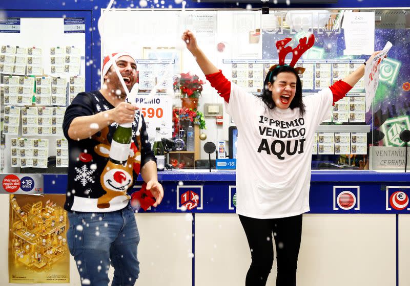 Owner Jose Maria Nogales and his wife Paloma Rodriguez celebrate selling the winning ticket of the biggest prize in Spain's Christmas lottery "El Gordo" (The Fat One) in Seville