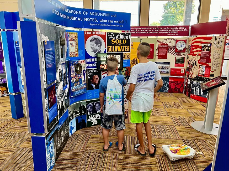 Kids interact with one of the many panels featured at the Voices and Votes: Democracy in America exhibit currently on display at the Maury County Library.