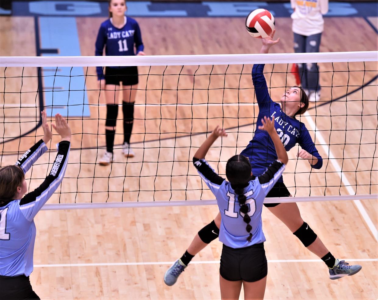 Rising Star's Kami Hawk, right, hits the ball as TLCA-Abilene's Symbri Miller (15) defends at the net. The Lady Eagles beat Rising Star 25-16, 25-13, 25-21 in the non-district match Aug. 29 at TLCA Eagle Gym in Abilene.