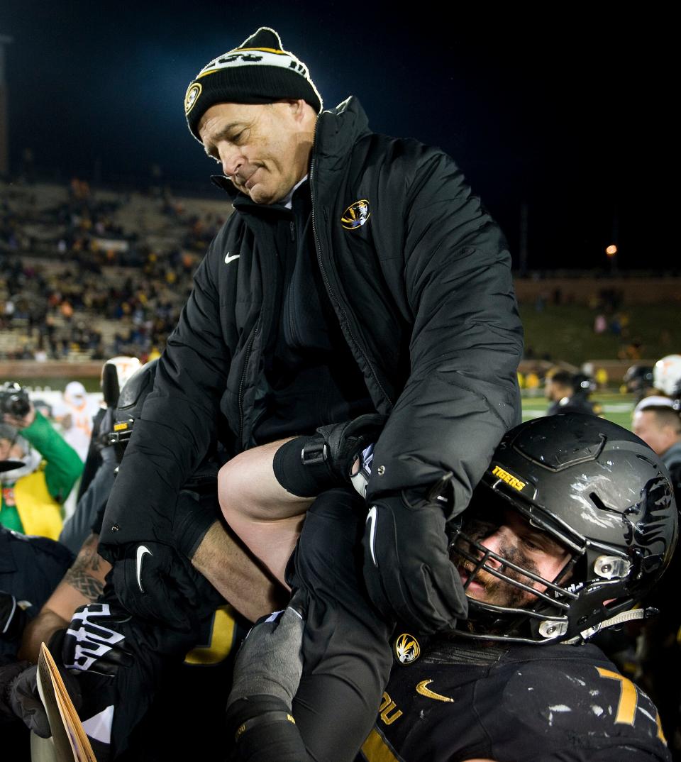 Missouri head coach Gary Pinkel is lifted up by offensive linemen Evan Boehm (77) and Connor McGovern (60) after a game against Tennessee on Nov. 21, 2015, at Faurot Field.
