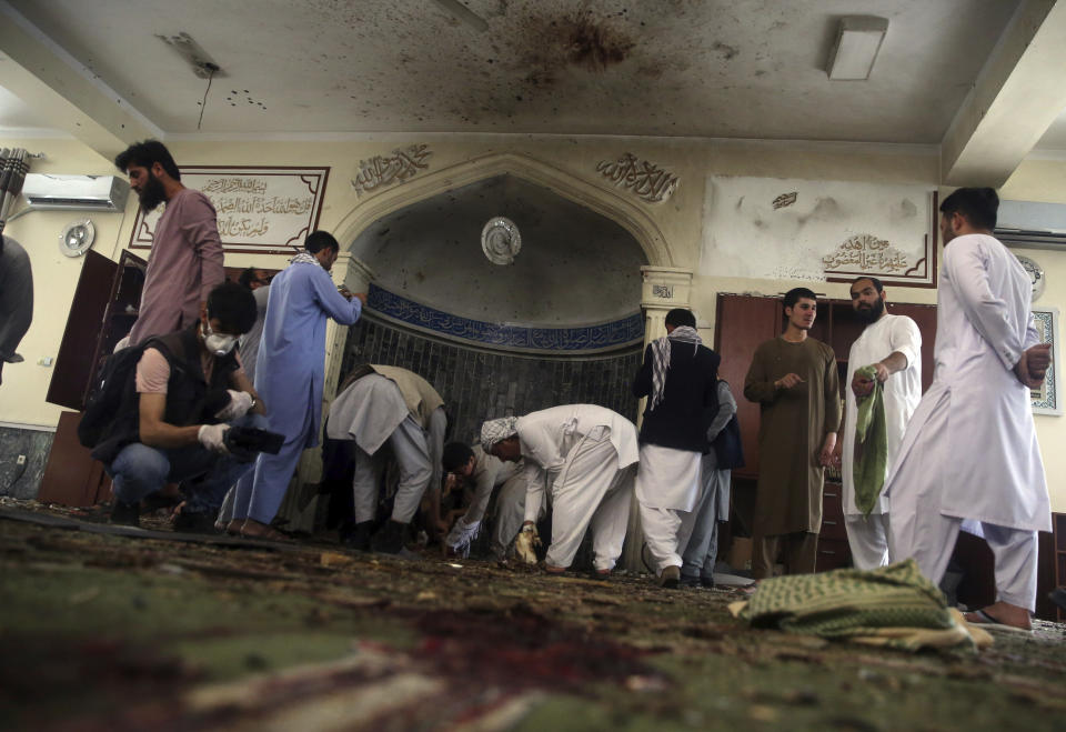 Afghans inspect the inside of a mosque following a bombing, in Kabul, Afghanistan, Friday, June 12, 2020. (AP Photo/Rahmat Gul)
