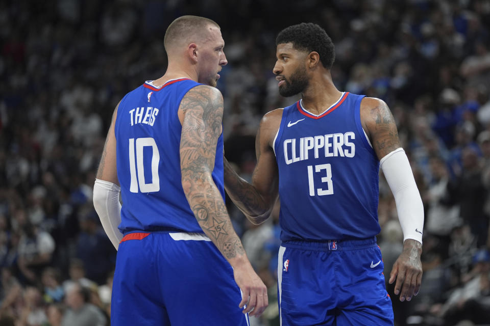 Los Angeles Clippers center Daniel Theis (10) and forward Paul George (13) talk during the second half of an NBA basketball game against the Minnesota Timberwolves, Sunday, March 3, 2024, in Minneapolis. (AP Photo/Abbie Parr)