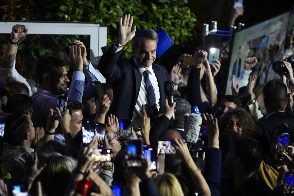 Greece's Prime Minister and leader of New Democracy Kyriakos Mitsotakis, center, addresses supporters at the headquarters of his party in Athens, Greece, Sunday, May 21, 2023. The conservative party of Greek Prime Minister Kyriakos Mitsotakis has won a landslide election but without enough parliamentary seats to form a government. (AP Photo/Thanassis Stavrakis)