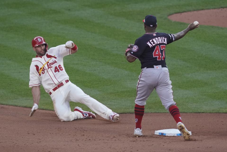 St. Louis Cardinals' Paul Goldschmidt is out at second as Washington Nationals' Howie Kendrick turns a double play on a ball hit by Yadier Molina during the seventh inning of Game 2 of the baseball National League Championship Series Saturday, Oct. 12, 2019, in St. Louis. (AP Photo/Charlie Riedel)