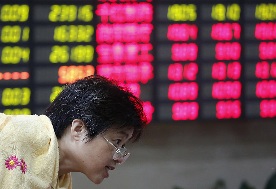 An investor looks at a stock price monitor at a private securities company Tuesday, Sept. 4, 2012, in Shanghai, China. Asian stock markets fell Tuesday as uncertainty persisted about what authorities in the U.S., China and Europe might do to deal with a souring global economy. (AP Photo)