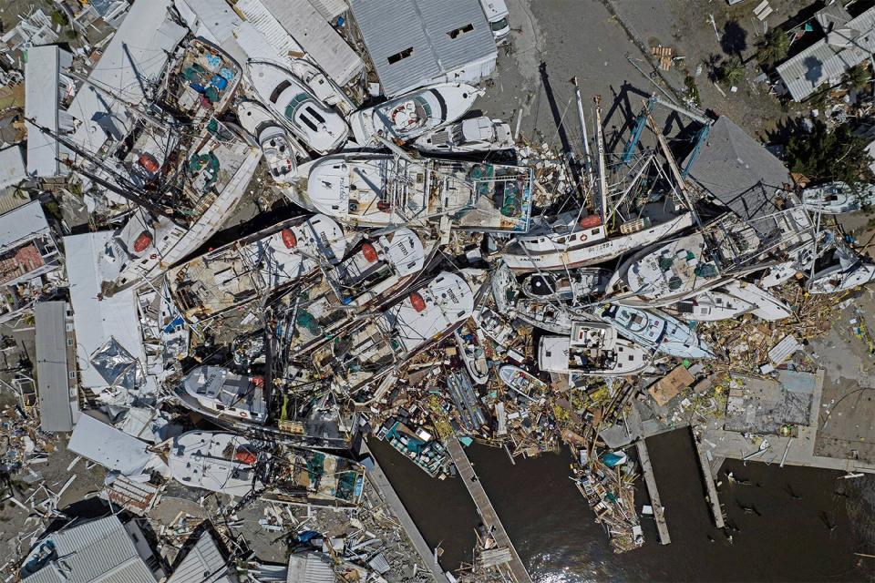 TOPSHOT - An aerial picture taken on September 29, 2022 shows piled up boats in the aftermath of Hurricane Ian in Fort Myers, Florida. - Hurricane Ian left much of coastal southwest Florida in darkness early on Thursday, bringing "catastrophic" flooding that left officials readying a huge emergency response to a storm of rare intensity. The National Hurricane Center said the eye of the "extremely dangerous" hurricane made landfall just after 3:00 pm (1900 GMT) on the barrier island of Cayo Costa, west of the city of Fort Myers. (Photo by Ricardo ARDUENGO / AFP) (Photo by RICARDO ARDUENGO/AFP via Getty Images)