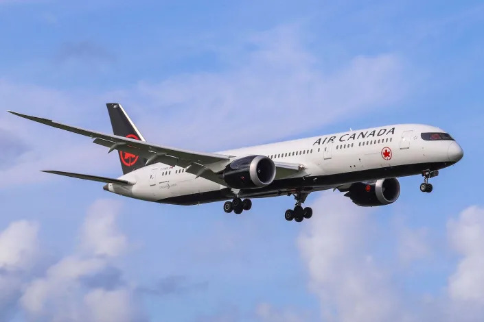 A Boeing 787-9 in Air Canada livery prepares to land.