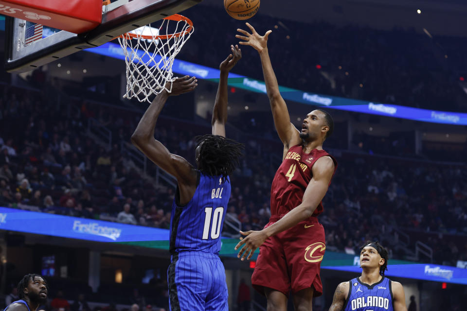 Cleveland Cavaliers center Evan Mobley (4) shoots against Orlando Magic center Bol Bol (10) during the first half of a NBA basketball game, Wednesday, Oct. 26, 2022, in Cleveland. (AP Photo/Ron Schwane)