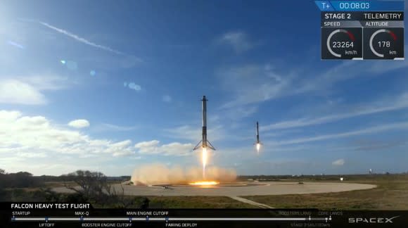 Two SpaceX rockets landing side-by-side