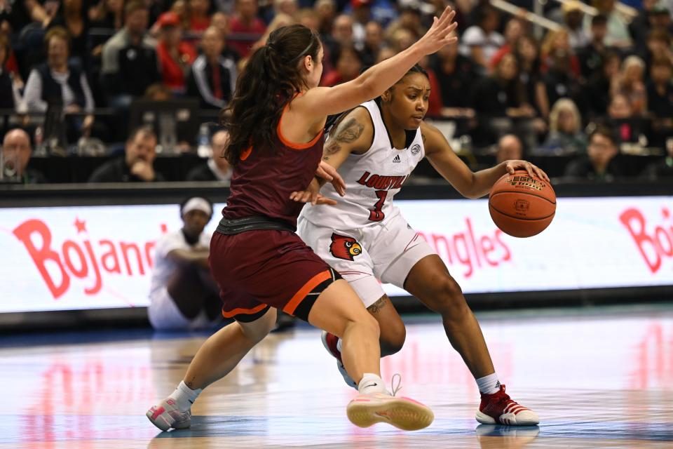 Mar 5, 2023; Greensboro, NC, USA; Louisville Cardinals guard Chrislyn Carr (3) drives around Virginia Tech Hokies guard Georgia Amoore (left) during the first half at Greensboro Coliseum. Mandatory Credit: William Howard-USA TODAY Sports