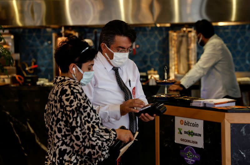 A customer makes payment at a restaurant in Istanbul