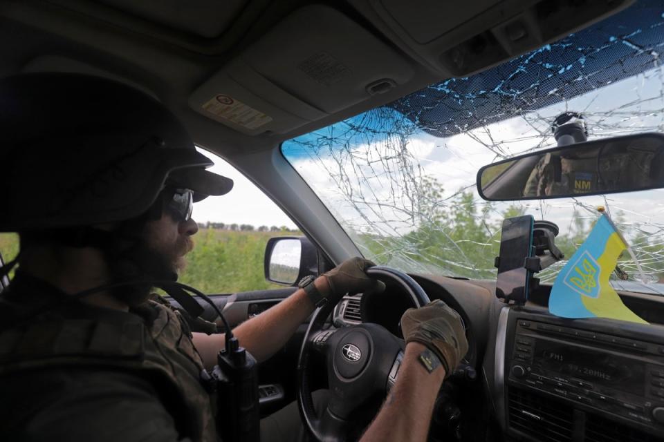 A Ukrainian serviceman driving in Donetsk on Wednesday (EPA)