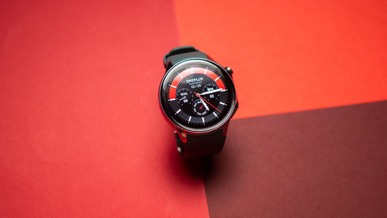  OnePlus Watch 2 watch face on red background. 