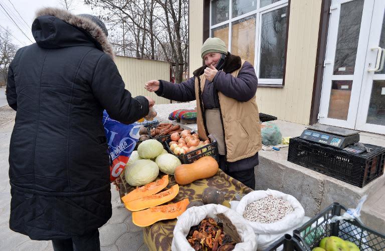 An elderly woman sells vegetables in the southeastern Ukrainian city of Mariupol, on February 25, 2015