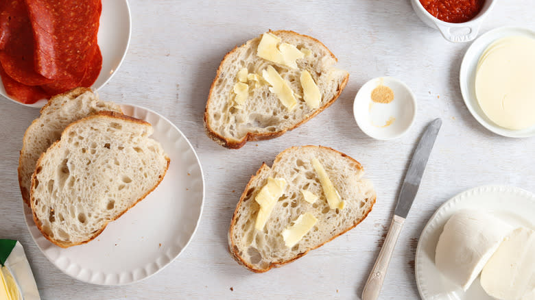 buttering bread on counter