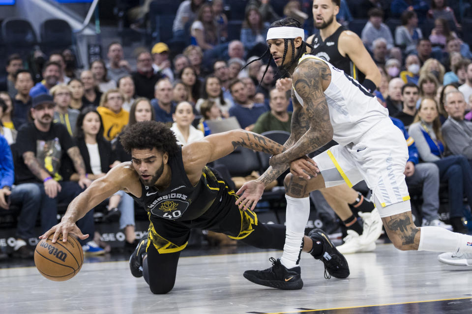 Golden State Warriors forward Anthony Lamb (40) gets possession of the ball in front of Utah Jazz guard Jordan Clarkson, front right, during the first half of an NBA basketball game in San Francisco, Friday, Nov. 25, 2022. (AP Photo/John Hefti)