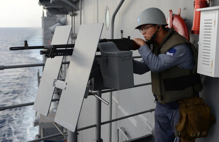 A Taiwanese sailor operates a machine gun on a Kidd-class destroyer as it patrols in the Taiwan Strait during a drill on May 15, 2013, aimed at defending its fishermen in disputed waters