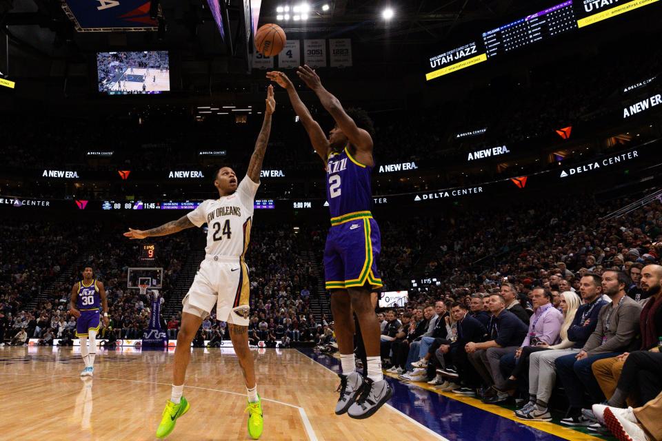 New Orleans Pelicans guard Jordan Hawkins (24) defends Utah Jazz guard Collin Sexton (2) on a 3-pointer during an NBA basketball game between the Utah Jazz and the New Orleans Pelicans at the Delta Center in Salt Lake City on Monday, Nov. 27, 2023. | Megan Nielsen, Deseret News