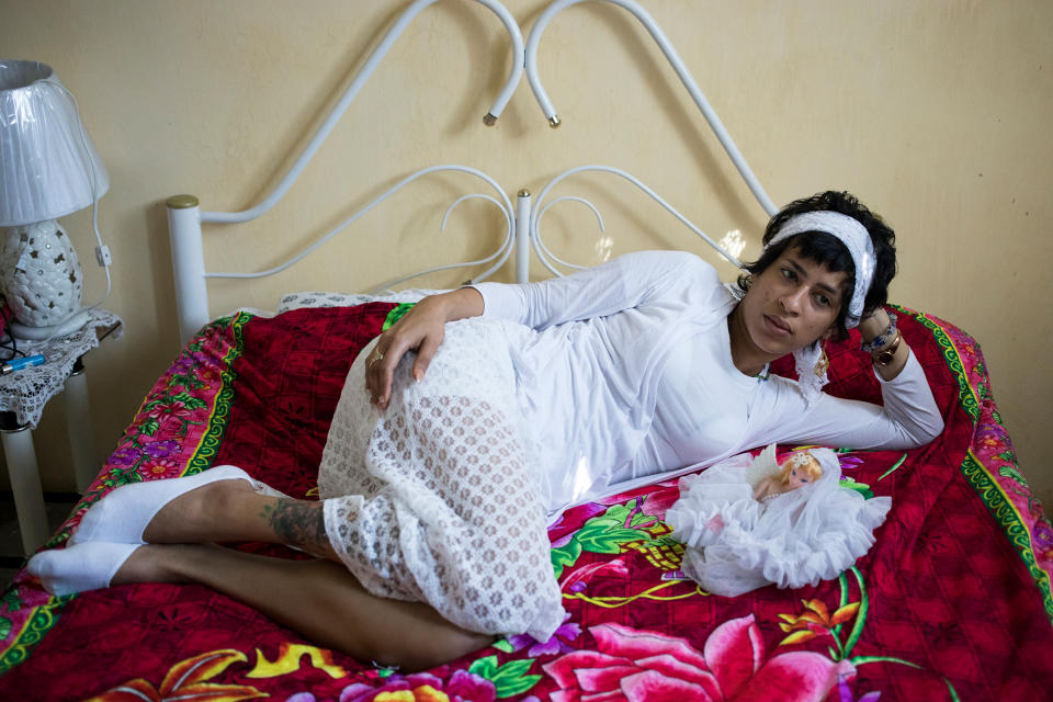 Liset at her home in Havana, Cuba, on Jan. 21. She is dressed in all white as part of her commitment to the process of becoming ordained as a priestess in Santería. Before leaving she made a promise to Yemaya, the goddess of the ocean, that she would become ordained in her honor if the goddess helped her make it safely to the U.S. Her spirituality helped her along the journey, and is also a major theme in Poole's book. | Lisette Poole