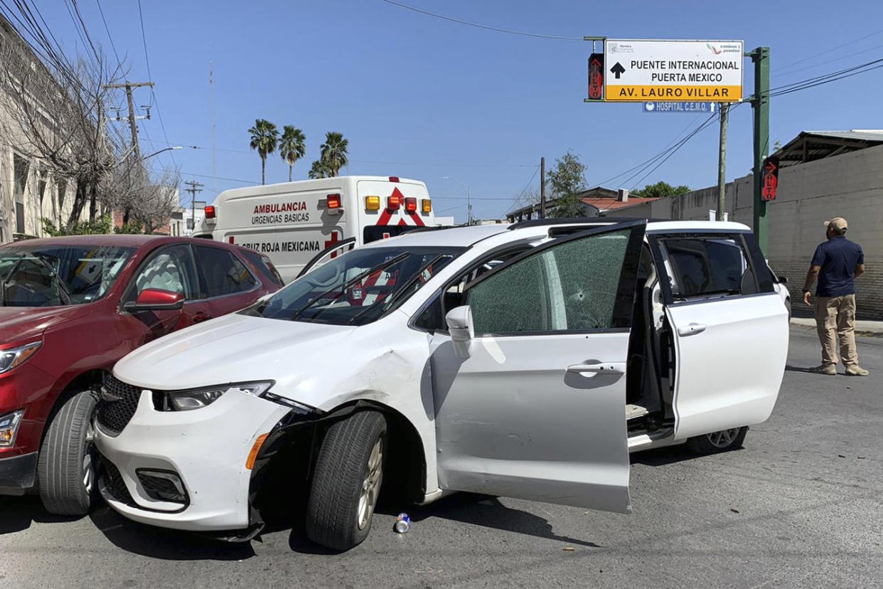 A member of the Mexican security forces stands near a white minivan with North Carolina plates and several bullet holes, at the crime scene where gunmen kidnapped four U.S. citizens who crossed into Mexico from Texas, on March 3, 2023. (AP)