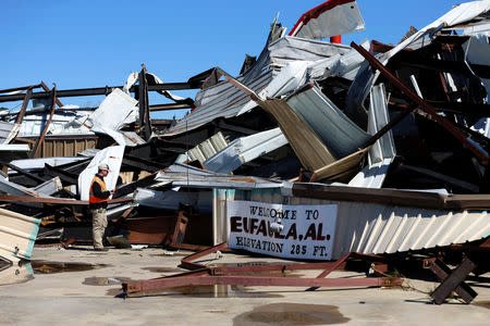 An Auburn University student studying tornadoes looks at damage to an airport hangar at the Eufaula Municipal Airport, after a string of tornadoes, in Eufaula, Alabama, U.S., March 5, 2019. REUTERS/Elijah Nouvelage
