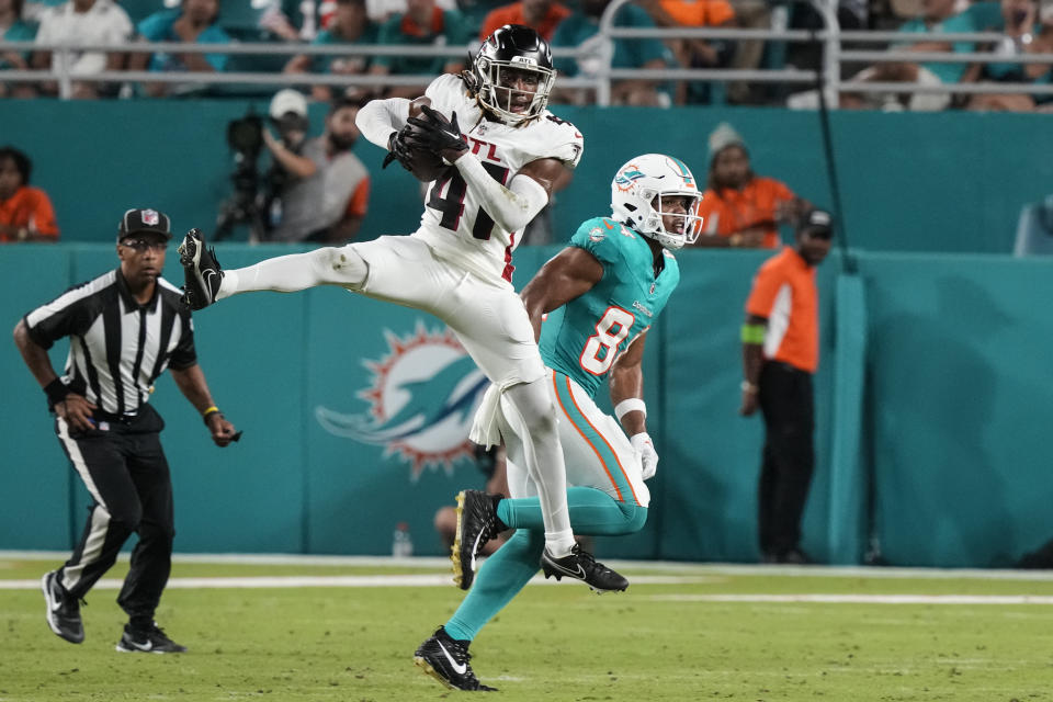 Atlanta Falcons safety Lukas Denis (41) intercepts a pass intended for Miami Dolphins tight end Elijah Higgins (84) in the second half of a preseason NFL football game, Friday, Aug. 11, 2023, in Miami Gardens, Fla. (AP Photo/Marta Lavandier)