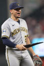 Milwaukee Brewers shortstop Willy Adames (27) picks up broken during a baseball game against the Atlanta Braves, Friday, July 30, 2021, in Atlanta. (AP Photo/Hakim Wright Sr.)