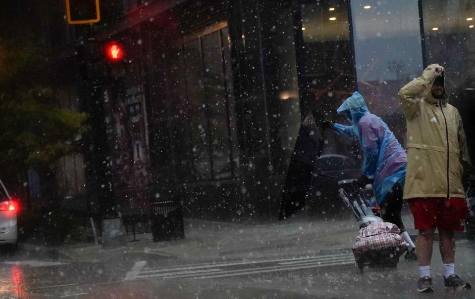 PHOTO: An umbrella is blown inside out as a person crosses the street during a storm in Washington, D.C., on Aug. 7, 2023. (Stefani Reynolds/AFP via Getty Images)