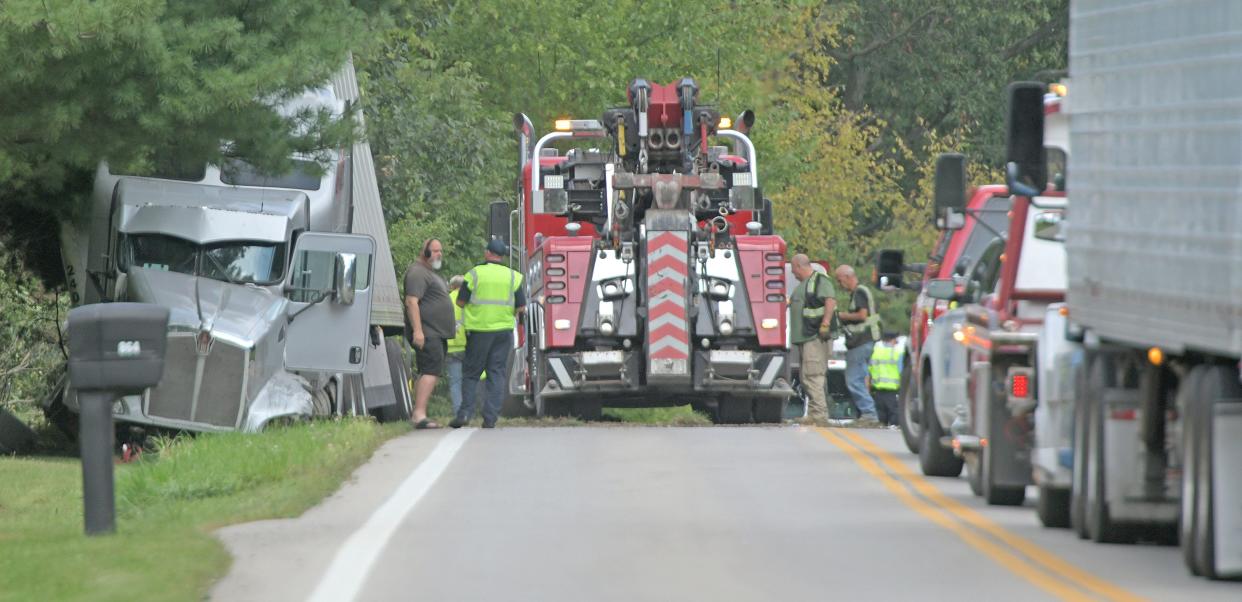 Workers try to free and clear a semi tractor trailer involved in an accident Monday on Ohio314 just north of Millsboro Road.