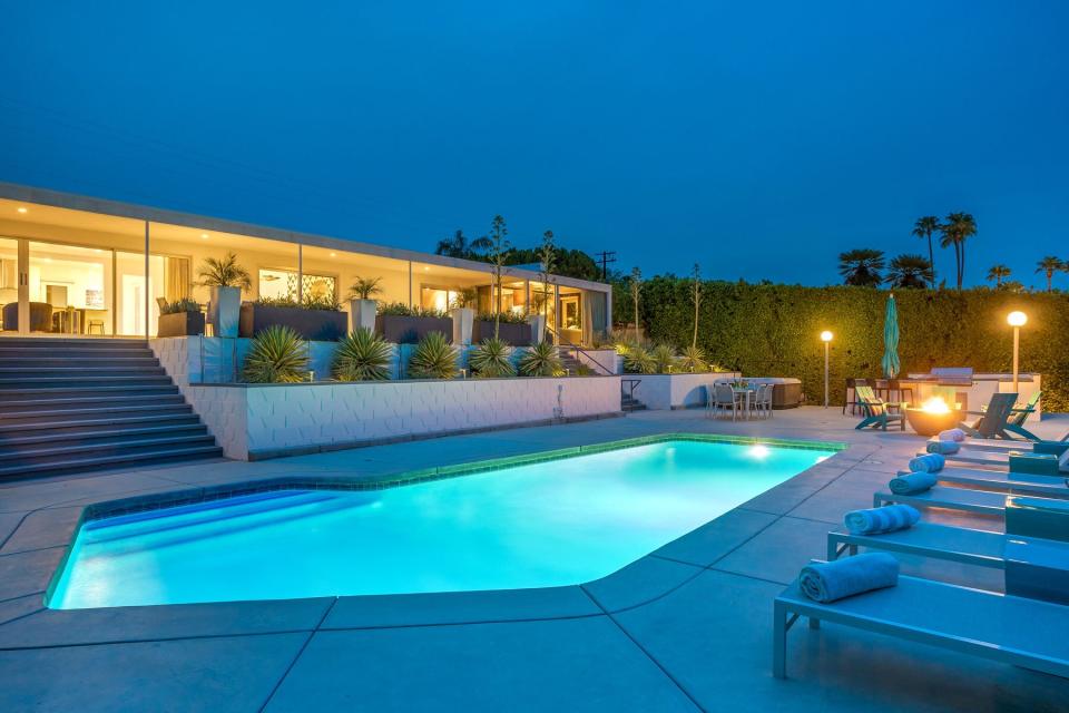 Nightime view of pool at home rental in Palm Springs, CA