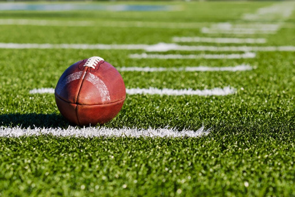 Football on Yardage Marker. Low Angle. Horizontial View / AdobeStock