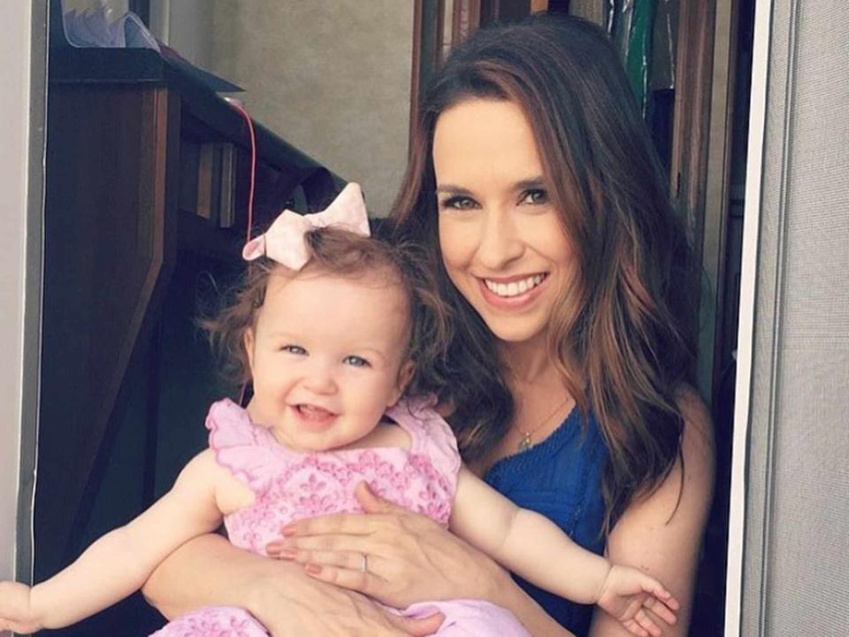 <p>Lacey Chabert Instagram</p> Lacey Chabert holding her daughter Julia Mimi Bella Nehdar while on set.