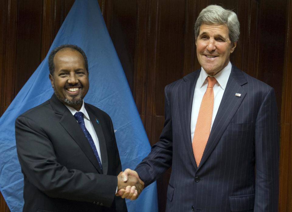 U.S. Secretary of State John Kerry, right, and Somali President Hassan Sheikh Mohamud shake hands prior to a meeting at Addis Ababa Bole International Airport in Addis Ababa, Ethiopia Saturday, May 3, 2014. America's top diplomat said Saturday the U.S. is ready to help increase its ties with Africa, but nations across the continent need to take stronger steps to ensure security and democracy for its people. (AP Photo/Saul Loeb, Pool)