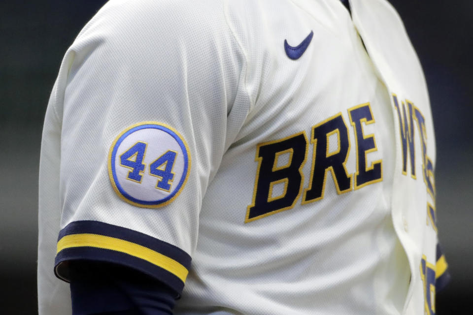 A patch to honor Hank Aaron is seen on the sleeve of Milwaukee Brewers' Keston Hiura during the first inning of an Opening Day baseball game against the Minnesota Twins Thursday, April 1, 2021, in Milwaukee. (AP Photo/Aaron Gash)