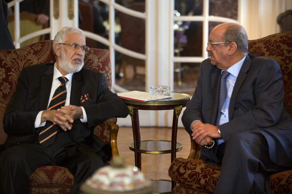 Libyan Foreign Minister, Mohamed Taher Siala, left, talks to Abdelkader Messahel, Algeria's Minister for African and Maghreb affairs, as they attend a ministerial meeting of countries neighboring Libya which include Egypt, Tunisia, Algeria, Sudan, Niger and Chad, as well as United Nations envoy, Martin Kobler, in Cairo, Egypt, Saturday, Jan. 21, 2017. Egyptian Foreign Minister Sameh Shoukry, said "Egypt is committed to upholding Libya's sovereignty, supporting its legitimate institutions and rejecting foreign interference in the crisis". MENA reported. (AP Photo/Amr Nabil)