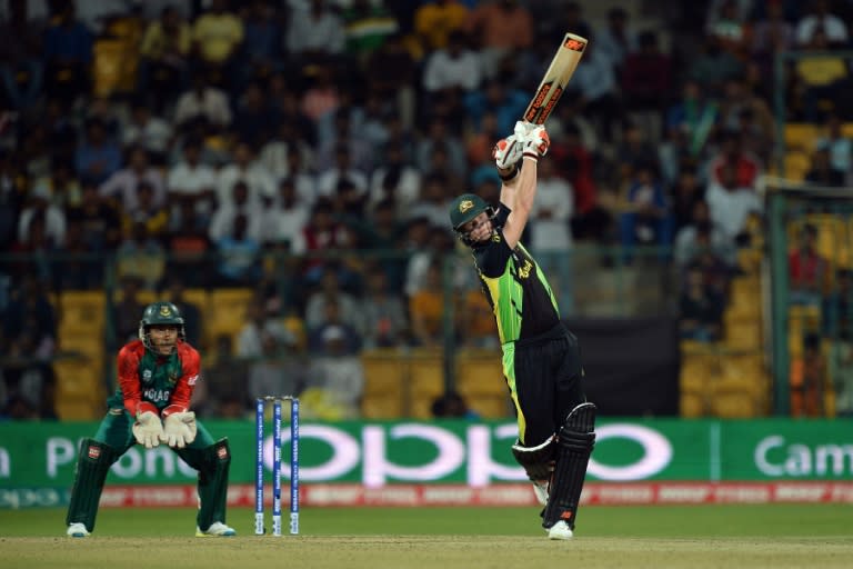 Australian batsman Steve Smith hits a six during the World T20 cricket tournament match between Australia and Bangladesh at The Chinnaswamy Stadium in Bangalore on March 21, 2016