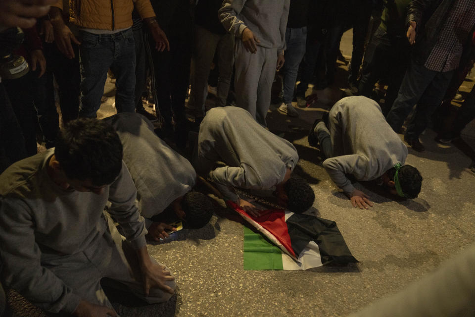 Former Palestinian prisoners who were released by the Israeli authorities, pray upon their arrival in the West Bank town of Beitunia, Friday, Nov. 24, 2023. The release came on the first day of a four-day cease-fire deal between Israel and Hamas during which the Gaza militants have pledged to release 50 hostages in exchange for 150 Palestinians imprisoned by Israel. (AP Photo/Nasser Nasser)