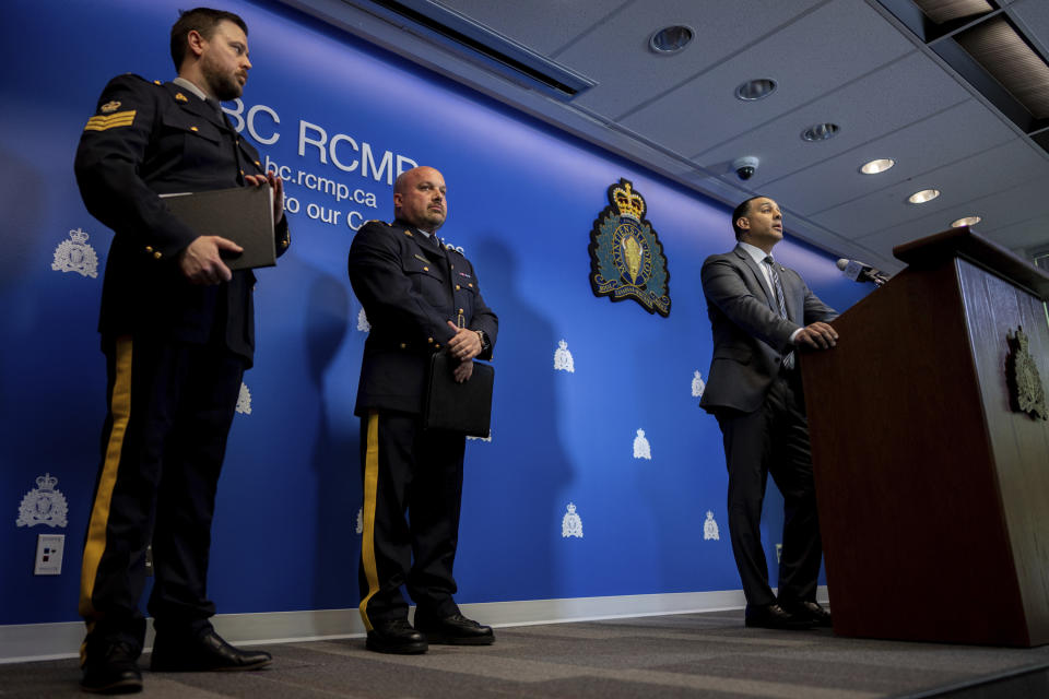 Superintendent Mandeep Mooker, right, Officer-in-Charge of IHIT speaks to media with Assistant Commissioner David Teboul, centre, during a news conference for an update on the Hardeep Singh Nijjar homicide investigation from June 18, 2023, in Surrey, B.C., Friday, May 3, 2024. (Ethan Cairns/The Canadian Press via AP)