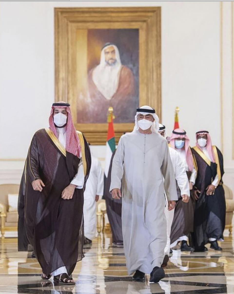 In this photo released by Saudi Press Agency, Saudi Crown Prince Mohammed bin Salman, left, arrives in Abu Dhabi to offer condolences to Sheikh Mohamed bin Zayed Al Nahyan, president of the UAE and ruler of Abu Dhabi, third, right, on the passing of Sheikh Khalifa bin Zayed Al Nahyan, the late president of the UAE, at the Presidential Airport in Abu Dhabi, UAE, Monday, May 16, 2022. (Saudi Press Agency via AP)